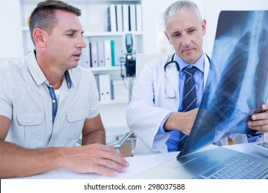 Doctor And Patient Looking At Xray In Medical Office