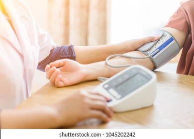 doctor and patient measuring blood pressure.Doctor checking woman patient arterial blood pressure.healthcare, hospital and medicine concept