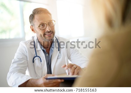 Doctor with patient in medical office