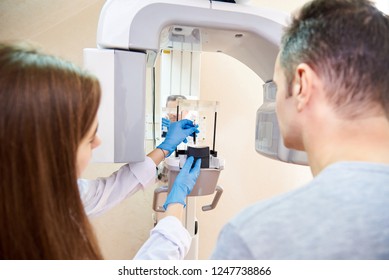 Doctor And Patient Next To X-ray Machine. Computer Diagnostics. Dental Tomography