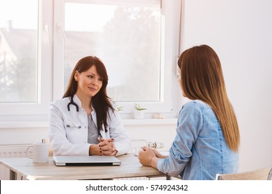 Doctor And Patient In Office Talking.