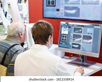 Doctor and patient with ophthalmic spectral optical coherent tomograph and monitor
