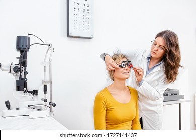 Doctor and patient in ophthalmology clinic doing eye test, checking vision