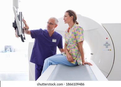 A Doctor And The Patient Reviewing Results On The Monitor At The CT Scanner In The Hospital