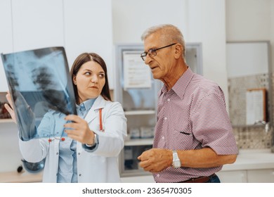 Doctor and Patient Reviewing X-Ray Results in Hospital Clinic - Powered by Shutterstock