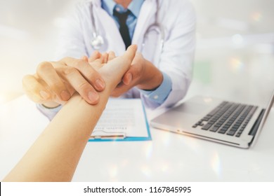 Doctor with patient. Routine health check and holding hands. Male medical doctor with young woman.