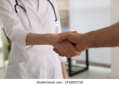 Doctor and patient shaking hands in clinic, closeup - Powered by Shutterstock