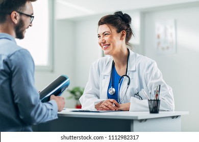 Doctor and patient sitting in doctor's office