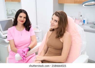 Doctor And Patient Sitting Side By Side In Medical Office