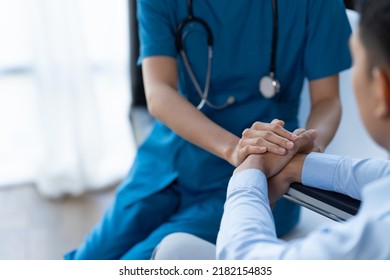 Doctor and patient sitting and talking at medical examination at hospital office, close-up. Therapist filling up medication history records. Medicine and healthcare concept. - Shutterstock ID 2182154835