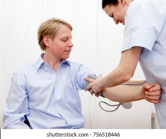 Doctor Patient Taking Blood Pressure