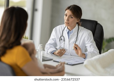 Doctor pediatrician and baby patient in clinic.Medicine, healthcare and pediatrics concept. - Powered by Shutterstock