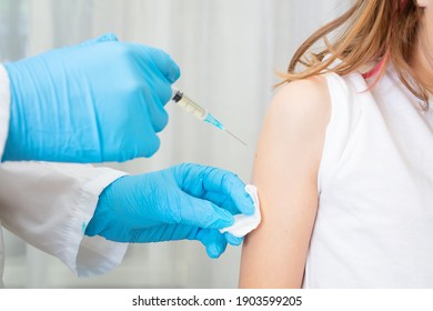 Doctor pediatrician injecting vaccine. High quality photo