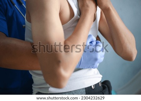 A doctor is performing the Heimlich maneuver on a patient who is choking and has difficulty breathing