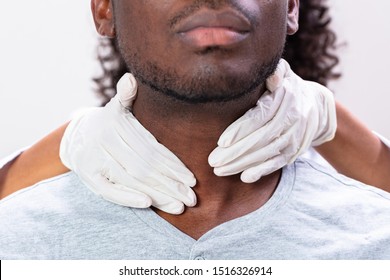 Doctor Performing Physical Exam Palpation Of The Thyroid Gland