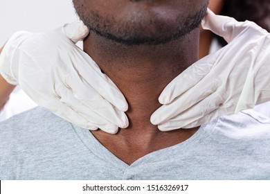 Doctor Performing Physical Exam Palpation Of The Thyroid Gland