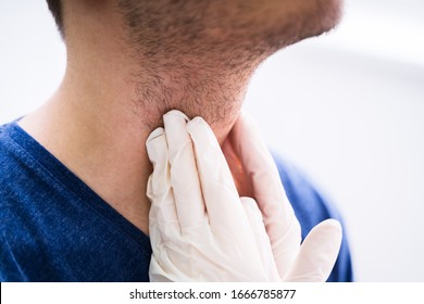 Doctor Performing Physical Exam Palpation Of The Thyroid Gland