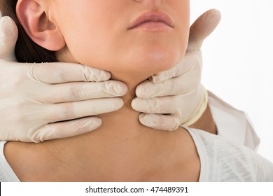 A Doctor Performing Physical Exam Palpation Of The Thyroid Gland