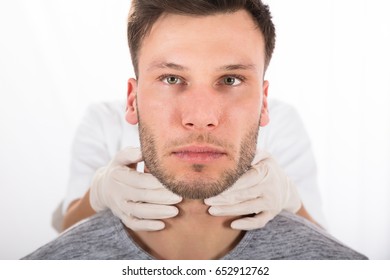 Doctor Performing Physical Exam Palpation Of The Thyroid Gland