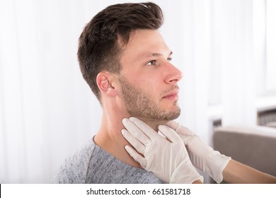 Doctor Performing Physical Exam Palpation Of The Thyroid Gland