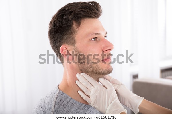 Doctor Performing Physical Exam Palpation Of The\
Thyroid Gland