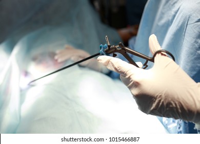 Doctor Performing Surgery On A Patient In Operation Room. Instruments For Laparoscopy. Surgeon Operating In Hospital Or Clinic. Medicine, Emergency Concept