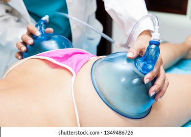 Doctor Performing A Vacuum Therapy Treatment For Buttocks Lifting On A Young Female Patient