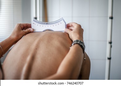 Doctor Performs A Medical Examination On A Patient Diagnosed With Scoliosis