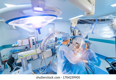 Doctor Performs Minimally-invasive Surgeon Using A Robotic Device. Minimal Invasive Surgical Innovation, Medical Robot Surgery With Endoscopy. Neurosurgery Concept.