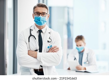 Doctor, Physician Or Healthcare Professional With Covid Face Mask In A Hospital For Medical Health Insurance Background. Innovation, Leadership And Excellence Male Gp Portrait With His Arms Crossed