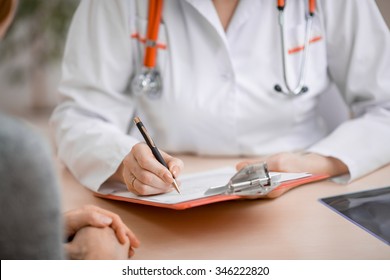 Doctor or physician writing diagnosis