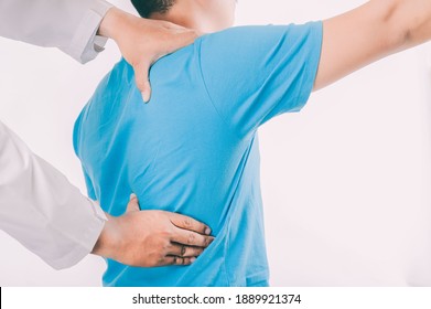 Doctor physiotherapist consulting with patient about elbow muscle pain problems.Physical therapy diagnosing concept - Shutterstock ID 1889921374