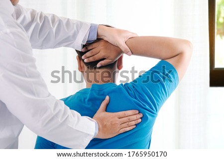 Doctor physiotherapist doing healing treatment on man's back.Back pain patient, treatment, medical doctor,.office syndrome