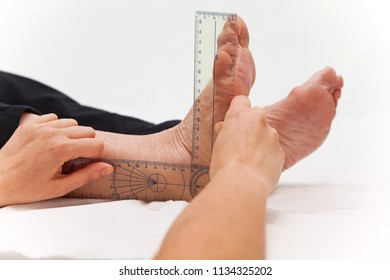 Doctor Or Physiotherapist Measuring Active Range Of Motion Using Manual Goniometer