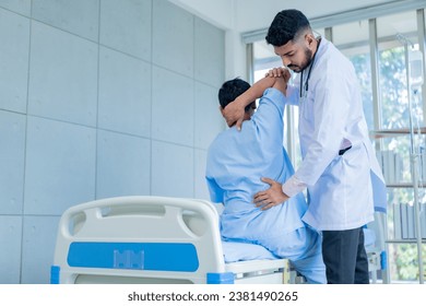 Doctor physiotherapist treating lower back pain patient after while giving exercising treatment on stretching in the hospital, Rehabilitation physiotherapy concept. - Powered by Shutterstock