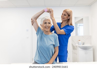 Doctor or Physiotherapist working examining treating injured arm of senior female patient, stretching and exercise, Doing the Rehabilitation therapy pain in clinic. - Powered by Shutterstock