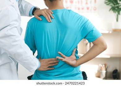 Doctor physiotherapists treat lower back pain in patients in the hospital. back injuries and back massages for muscle recovery.The concept of treating illnesses with physical therapy. - Powered by Shutterstock