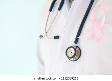doctor with pink ribbon concept breast cancer and stethoscope.