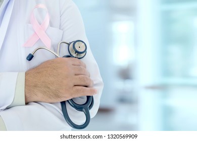 doctor with pink ribbon concept breast cancer and stethoscope.