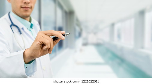 Doctor pointing pen at empty copy space for your text. Healthcare and medical service. - Shutterstock ID 1221622015