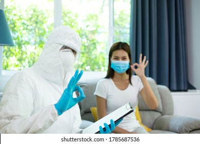 Doctor In PPE Suit Show Result With Finger For Negative Result.Visit Patient Wear Mask.Technical Team Check And Test Who Is Possible Coronavirus Infection.