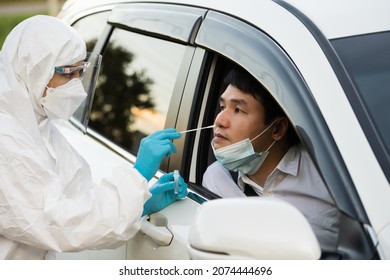 Doctor In PPE Suit Test Coronavirus(covid-19) To Man In Car By Nasal Swab Cotton, Drive Thru Test Fast Track