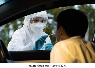 Doctor In PPE Suit Test Coronavirus(covid-19) To Man In Car By Nasal Swab Cotton, Drive Thru Test Fast Track