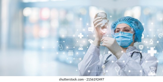 The doctor prepares the system for intra-drip infusions on a blurred background. - Powered by Shutterstock