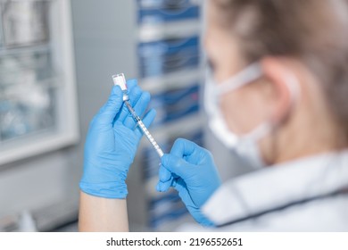 Doctor Prepares The Vaccine For The Patient. She Uses Safety Measures And She Calculates The Correct Dose.