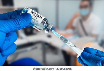 Doctor Preparing A Dose Of Influenza (Flu) Vaccine For A Patient. Doctor With Influenza (Flu) Or Grippe Vaccine Bottle For The Annual Flu Disease Prevention Campaign