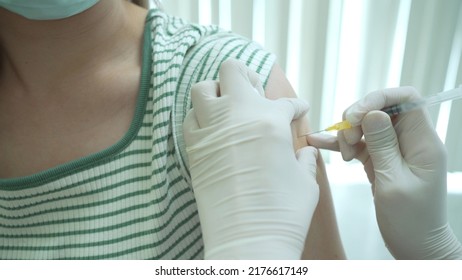 Doctor Preparing A Dose Of Vaccine For Injection At Patient Left Arm Close Up With Copyspace. Healthcare And Medical Service Concept. COVID-19 Or Coronavirus Cure Vaccine Injection.