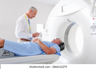 Doctor Preparing A Patient For CT Scan In The Hospital