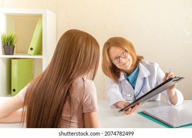 Doctor Prescribes Pills To A Teenager In A Medical Clinic