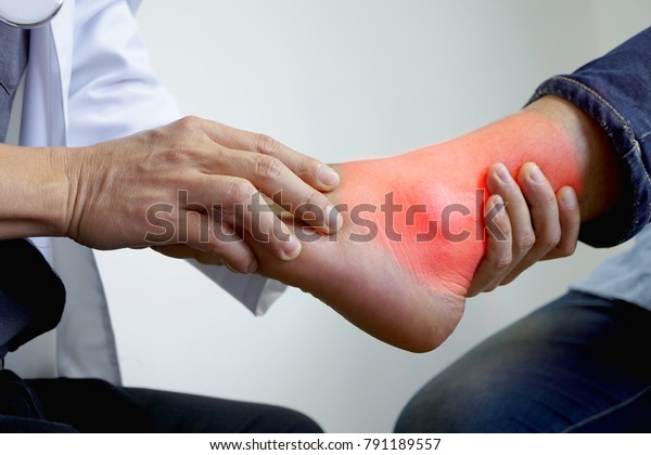 The doctor is pressing the ankle. To\
see the pain in the treatment of gout, bone\
disease.